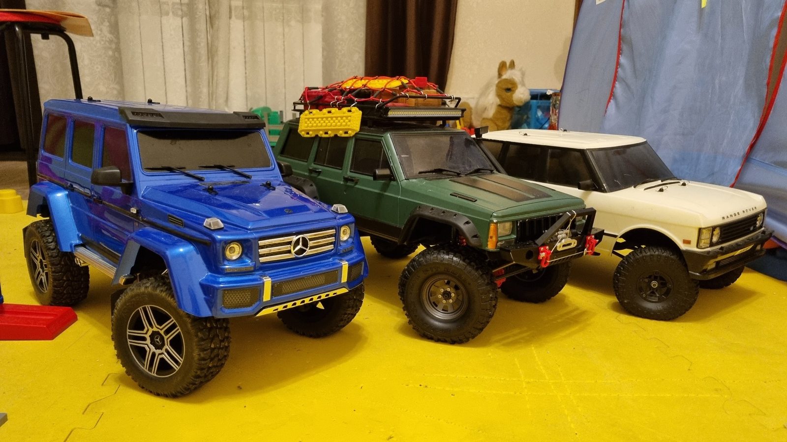 RC trail trucks in the garage